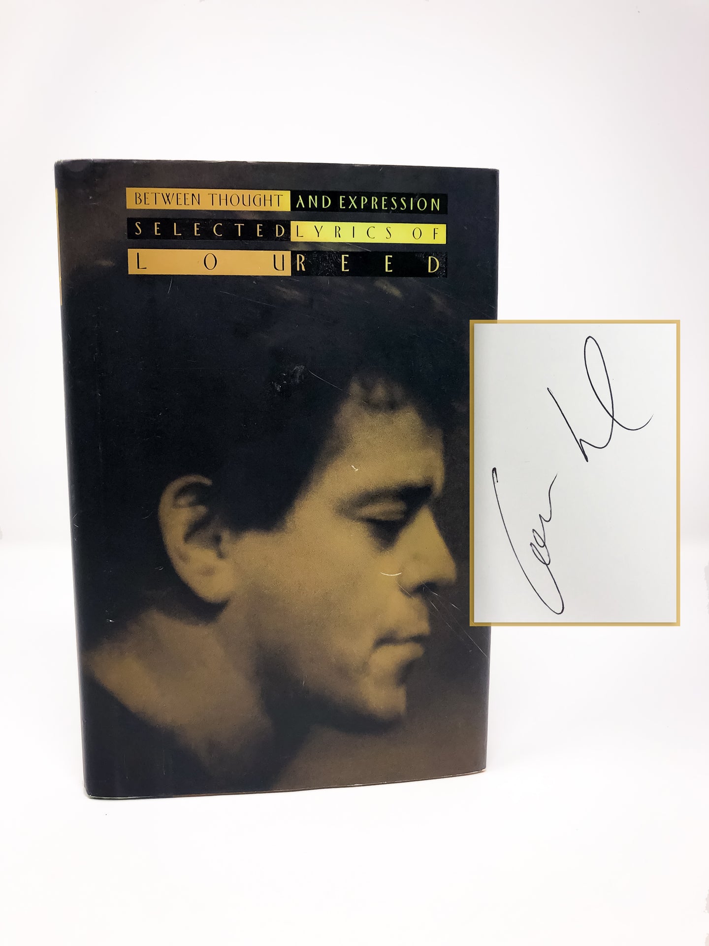 A signed first edition of Between Thought and Expression by Lou Reed